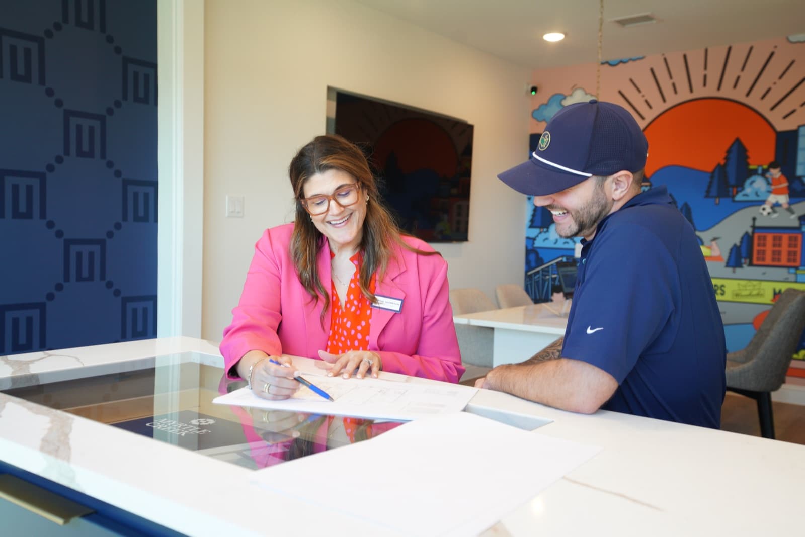 UnionMain Homes team members reviewing plans together at a sales center