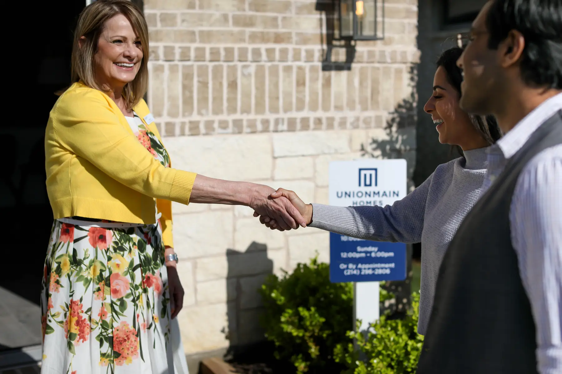 A UnionMain host welcoming guests to a model home